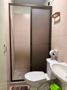 a bathroom with a shower and a toilet and a sink at Hotel Casa Verde Guatapé in Guatapé