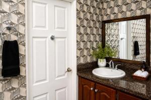 a bathroom with a sink and a mirror at Piton Views & Sunset Balcony, Minutes to Beaches in Soufrière