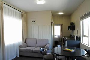 a living room with a couch and a table at City Close Motel in Napier