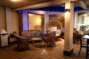 a room with chairs and a table and a bird cage at Kaakupe Praia Hotel in Guaratuba