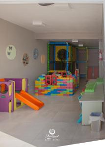 a childrens play room with colorful playground equipment at Kaakupe Praia Hotel in Guaratuba +40 photos