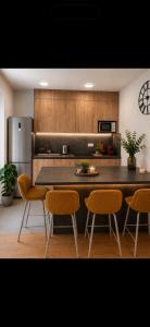 a kitchen with a table and chairs and a refrigerator at Apartman PEPI LUXURY in Novi Zagreb
