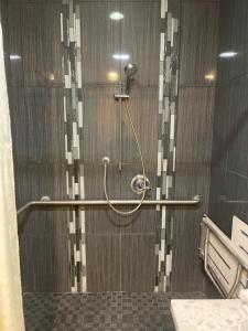 a shower with a hand rail in a bathroom at Monterey Fairgrounds Inn in Monterey +19 photos
