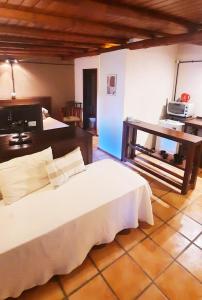 a bedroom with a bed and a table in a room at GuardiaPiemontese Aparts in Capilla del Monte +39 photos