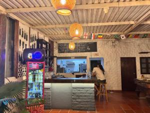 a woman standing at the counter of a restaurant at Hostal Casa Lulú Santa Marta in Santa Marta
