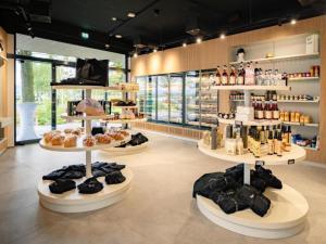 a store with several shelves of donuts on display at Guesthouse Naturgarten in Breitenbrunn +11 photos