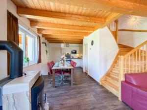 a kitchen and living room with a table and chairs at Kipaji 2 in Kötschach