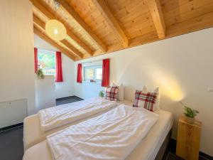 a bedroom with two beds in a room with wooden ceilings at Kipaji 2 in Kötschach