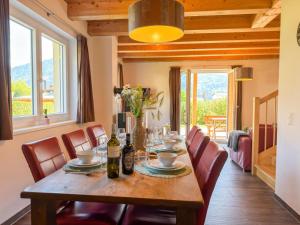 a dining room with a wooden table and chairs at Kipaji 3 in Kötschach
