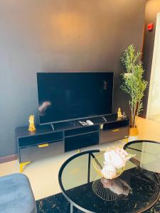 a living room with a table and a large tv at Colombo Trizen Nuva Apartments in Colombo +156 photos