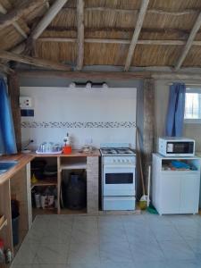 a kitchen with a white stove and a counter at Quinta Doña Delia in Agote