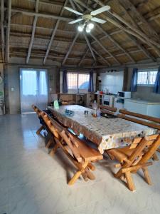 a large table with benches in a room at Quinta Doña Delia in Agote
