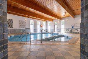 a pool in a house with an indoor swimming pool at Holiday Inn Newport by IHG in Newport