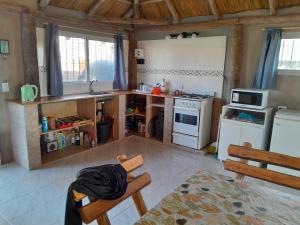 a kitchen with a sink and a stove top oven at Quinta Doña Delia in Agote