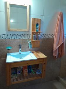 a bathroom with a sink and a mirror at Quinta Doña Delia in Agote
