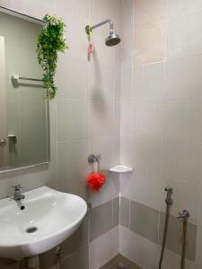 a bathroom with a sink and a mirror at EM Suite Homestay Dperdana Apartment Kota Bharu in Kota Bharu +11 photos
