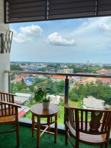 a room with a table and chairs and a large window at EM Suite Homestay Dperdana Apartment Kota Bharu in Kota Bharu