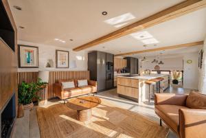 a living room with a couch and a table at Treloggas Retreat in Truro