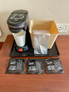 a coffee maker sitting on a table with some food at Monterey Fairgrounds Inn in Monterey