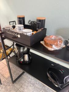 a table with a box of food and a loaf of bread at APARTAMENTO SIMPLES E ACONCHEGANTE in Paraty