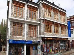 a building on a city street with a store at Nezer View Guest House in Leh