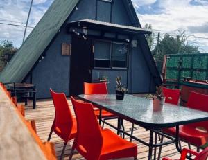 a patio with a table and chairs on a deck at Los boldos in Concón
