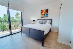 a bedroom with a bed and a balcony at Gold coast beautiful house with private pool in Palm-Eagle Beach