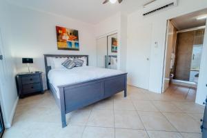 a bedroom with a bed and a table and a window at Gold coast beautiful house with private pool in Palm-Eagle Beach