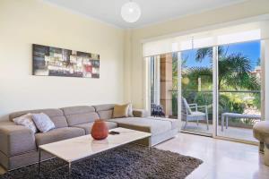 a living room with a couch and a table at LUXURIOUS APARTMENT IN LEVENT FRONT EAGLE BEACH in Palm-Eagle Beach