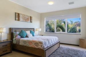 a bedroom with a bed and a large window at LUXURIOUS APARTMENT IN LEVENT FRONT EAGLE BEACH in Palm-Eagle Beach +67 photos