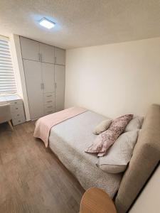 a bedroom with a bed and a couch at Modern and cozy in Riobamba in Riobamba