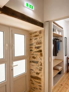 a door to a room with a stone wall at Lichno Spirit in Vourliótai