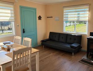 a living room with a black couch and a table at cabañas notuco in Natuco
