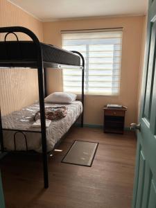 a bedroom with a bunk bed and a window at cabañas notuco in Natuco