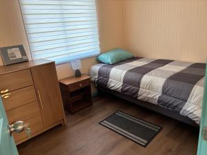 a small bedroom with a bed and a window at cabañas notuco in Natuco +5 photos