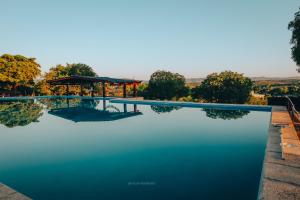 a view of a swimming pool with trees in the background at Agua Dorada Apart in Cavalango +1 photo