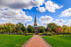 a building with a clock tower in a park at Kimpton Cardinal Hotel by IHG in Winston-Salem
