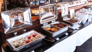 a buffet with several trays of food on a counter at JR-East Hotel Mets Fukushima in Fukushima