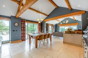 a kitchen with blue walls and a table and chairs at 2 Bed in Leyburn oc-g0099 in Constable Burton