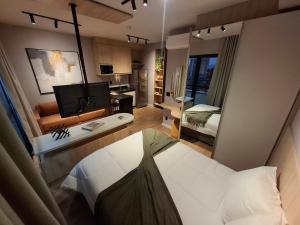 a living room with a bed and a television at SKY design Alphaville by Rhouses in Barueri +71 photos