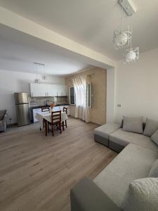 a living room with a couch and a table at Mateo Apartaments in Vlorë
