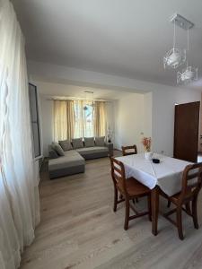 a living room with a table and a couch at Mateo Apartaments in Vlorë +18 photos