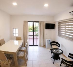 a living room with a dining room table and chairs at Dorrego Apart 3 in Guaymallen