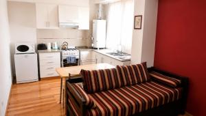 a living room with a couch and a kitchen at Dorrego Apart 3 in Guaymallen