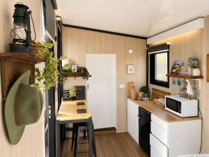 a small kitchen with a table in a tiny house at Field and Fleece Farm Stay by Tiny Away in Claremont