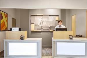 a man standing in front of a desk with a laptop at Holiday Inn Express Rolla by IHG in Rolla +52 photos