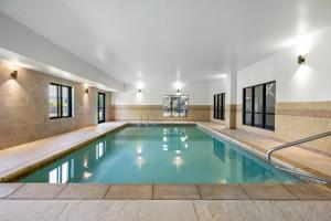 an indoor pool with blue water in a building at Holiday Inn Express Rolla by IHG in Rolla