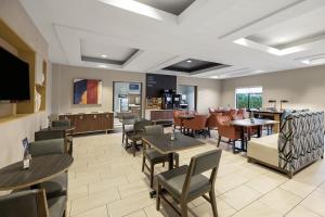 a restaurant with tables and chairs and a kitchen at Holiday Inn Express Rolla by IHG in Rolla