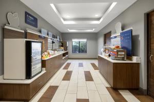 a kitchen with a counter and a cafeteria at Holiday Inn Express Rolla by IHG in Rolla