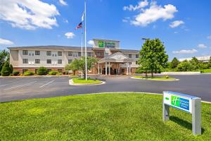 a hotel with a sign in front of a parking lot at Holiday Inn Express Rolla by IHG in Rolla